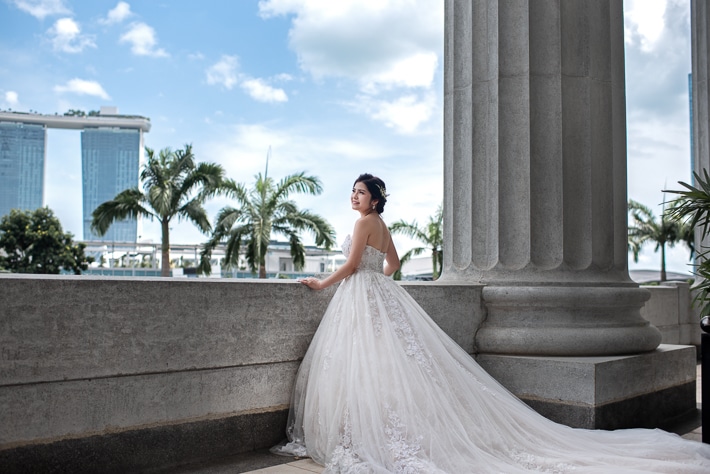 Bride's Engagement Photoshoot at Fullerton Hotel Singapore. Overlooking Marina Bay Sands